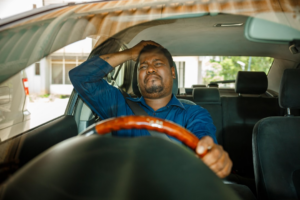 a man sitting in the driver's seat of a car — Foto por Ali Mkumbwa na Unsplash