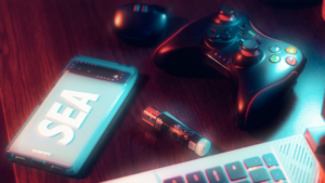 a cell phone, a pen, and a game controller on a table — Foto por Dhilip Antony na Unsplash