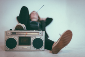 woman laying on bed near gray radio — Foto por Eric Nopanen na Unsplash
