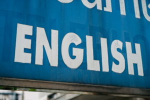 a close up of a blue sign with white lettering — Foto por Markus Winkler na Unsplash