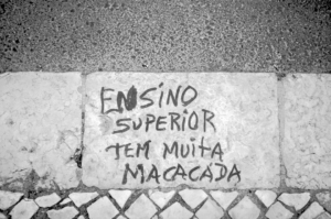 a cement wall with graffiti written on it — Foto por Manuel Palmeira na Unsplash